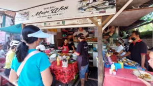 Gerai makanan jalanan halal di Bali dengan pengunjung menikmati hidangan lokal.